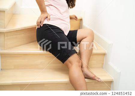 Asian lady fall down the stairs and pain at hip and waist because slippery surfaces. Asian lady fall down the stairs and pain at hip and waist because slippery surfaces. 124851452