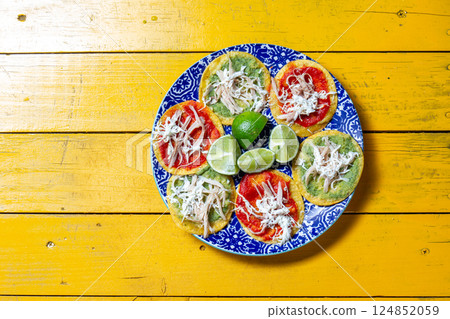 Festive Mexican tortillas with Aztec soup, chalupas, and lime garnish for celebrations like Cinco de Mayo and Dia de los Muertos 124852059