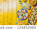 Colorful Mexican food spread featuring chalupas, tortilla soup, and traditional dishes for celebration with copy space 124852060