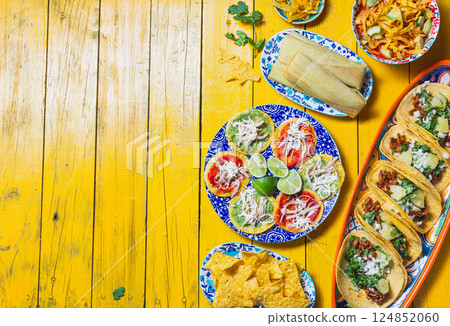 Colorful Mexican food spread featuring chalupas, tortilla soup, and traditional dishes for celebration with copy space 124852060