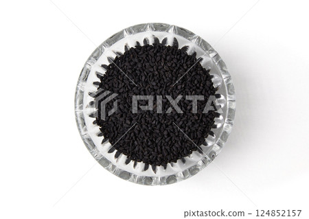 Sativa nigella in a carved crystal bowl isolated on a white background Sativa nigella in a carved crystal bowl isolated on a white background 124852157