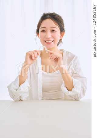 Female with mouthpiece correction 124852167