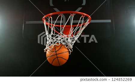 Detail of basketball ball hitting the hoop, top view. Isolated on black background. Detail of basketball ball hitting the hoop, top view. Isolated on black background. 124852269