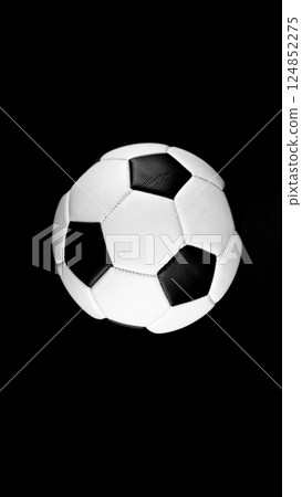 Detail of soccer ball, top view. Isolated on black background. 124852275
