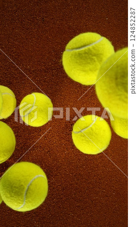 Tennis balls falling on clay surface. Tennis balls falling on clay surface. 124852287