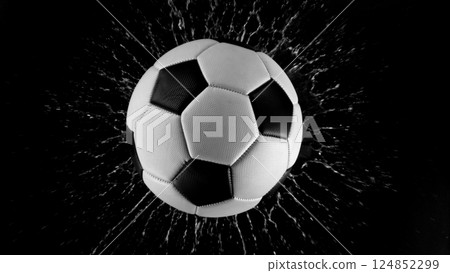 Detail of soccer ball with splashing water. Isolated on black background. 124852299