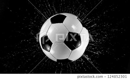 Detail of soccer ball with splashing water. Isolated on black background. Detail of soccer ball with splashing water. Isolated on black background. 124852301