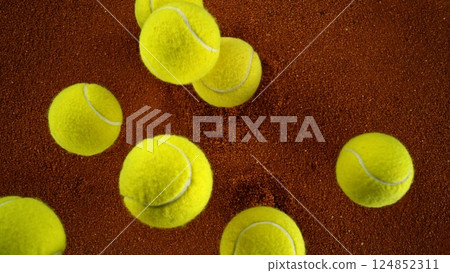 Tennis balls falling on clay surface. 124852311