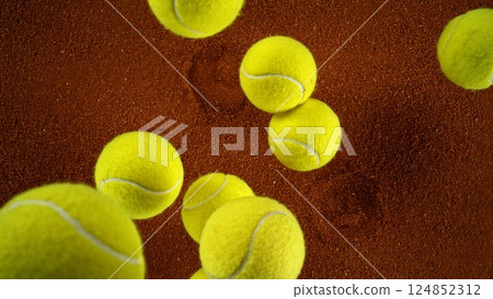 Tennis balls falling on clay surface. 124852312