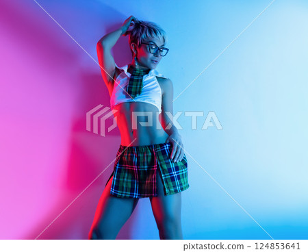 A sexy girl in an erotic school costume with a plaid skirt from a sex shop poses erotically on a neon background from a copy paste A sexy girl in an erotic school costume with a plaid skirt from a sex shop poses erotically on a neon background from a copy paste 124853641