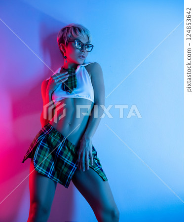 A sexy girl in an erotic school costume with a plaid skirt from a sex shop poses erotically on a neon background from a copy paste A sexy girl in an erotic school costume with a plaid skirt from a sex shop poses erotically on a neon background from a copy paste 124853642
