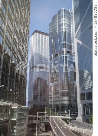 Modern skyscrapers reflect city skyline in bright daylight 124853788