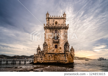 Belem Tower at sunset casts a golden glow on the Tagus River in beautiful Lisbon, Portugal. 124853815