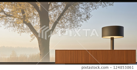 Morning light filters through large window showcasing tree and sleek lamp in modern setting 124853861