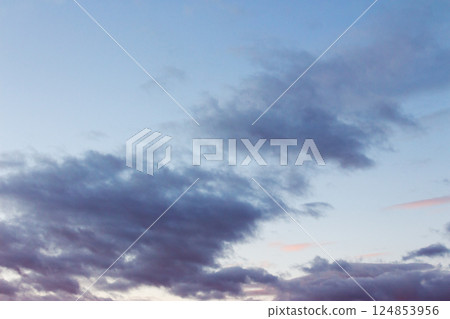 cumulus clouds on the sky at twilight. meteorology forecast. beautiful nature background in colorful light at sunset. windy winter conditions 124853956
