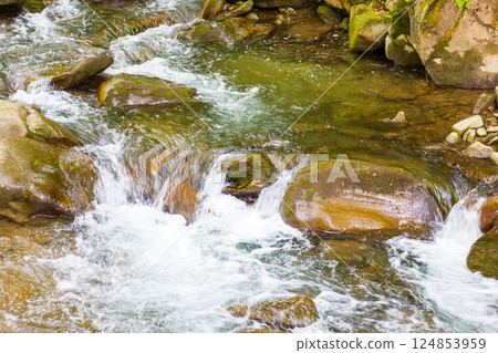 rapid water stream among rocks and stones. beautiful nature background in romanian mountains. closeup view from above 124853959