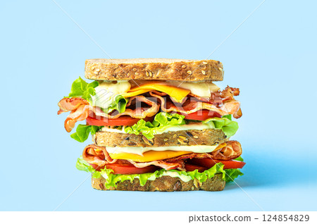 Double BLT sandwich with cheese on blue background 124854829