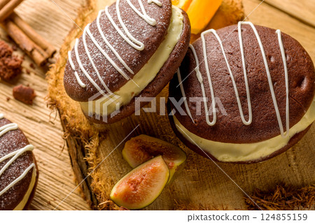 Whoopie pie with orange cream. Delicious homemade dessert Whoopie pie with orange cream. Delicious homemade dessert 124855159