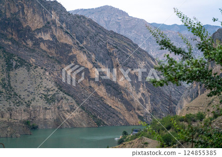 A mountain range with a river running through it 124855385