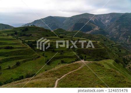 Chokhsky terraces Dagestan. Landscape of mountainous Dagestan with terraced fields and peaks mountains in the distance. Chokhsky terraces Dagestan. Landscape of mountainous Dagestan with terraced fields and peaks mountains in the distance. 124855476