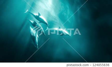 Four dolphins are swimming together in the deep blue ocean, creating a beautiful and serene underwater scene, with sunbeams filtering through the water 124855636