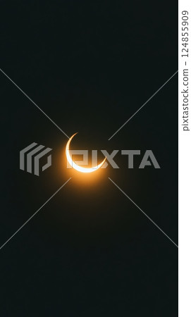 Majestic partial solar eclipse forming a glowing crescent shape against the dark backdrop of the sky, showcasing the celestial beauty and wonder of astronomical events 124855909