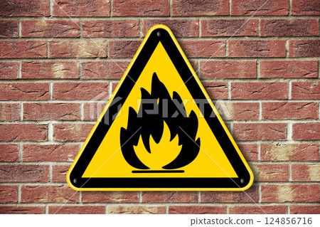 Fire hazard warning sign on a brick wall background 124856716