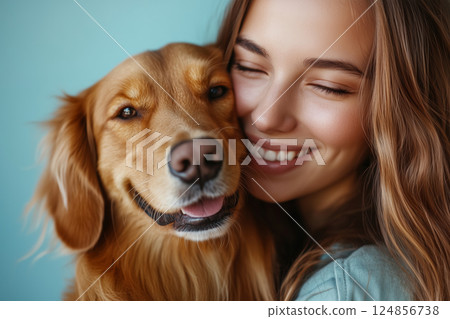 Young woman joyfully embraces her golden retriever in a warm moment 124856738
