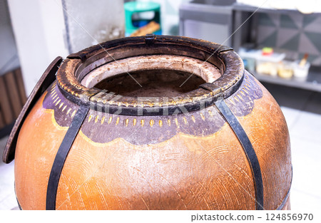 Gas heated tandoor oven for making traditional asian flat bread in a chain store 124856970