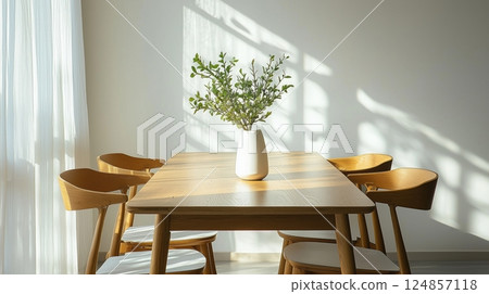 Scandinavian-style dining space with morning light streaming in 124857118