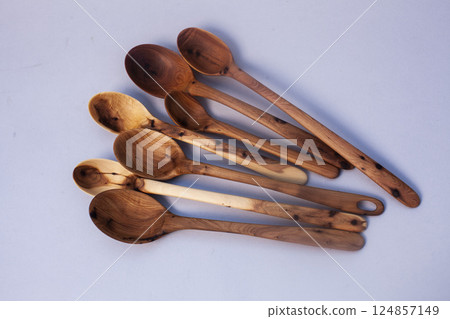 Wooden kitchen utensils stacked view isolated Wooden kitchen utensils stacked view isolated 124857149