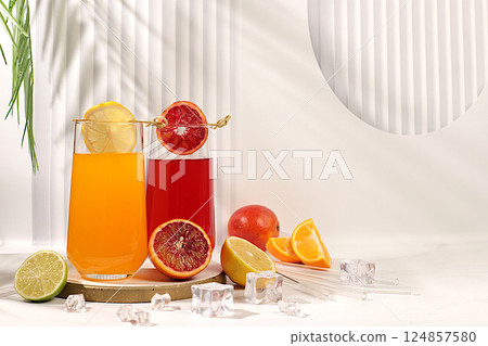Orange juice, thick smoothie and oranges, grapefruit, lime, blood orange and lemon on elegant kitchen table. Detox diet and weight loss concept, summer vitamin drinks, Modern still life with citrus 124857580