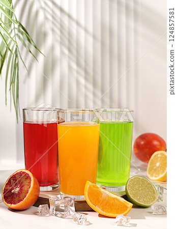Modern still life with citrus fruits. Orange juice, thick smoothie and oranges, grapefruit, lime, blood orange and lemon on elegant kitchen table. Detox diet and weight loss concept, summer drinks, 124857581