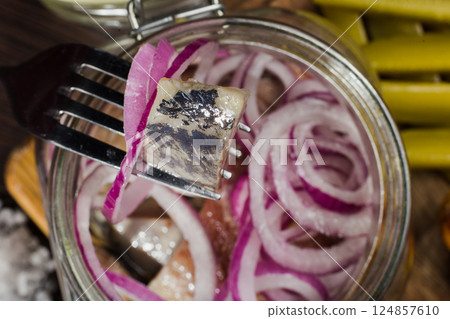 Herring with onions in a glass jar with potatoes 124857610