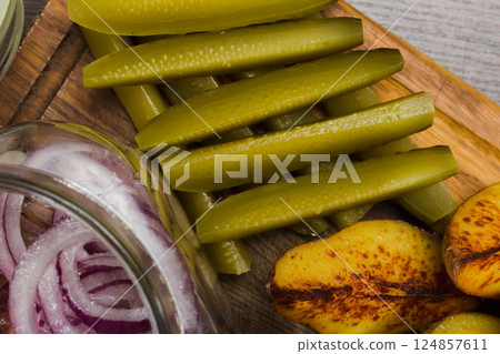 Herring with onions in a glass jar with potatoes 124857611