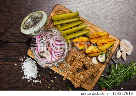 Herring with onions in a glass jar with potatoes Herring with onions in a glass jar with potatoes 124857619