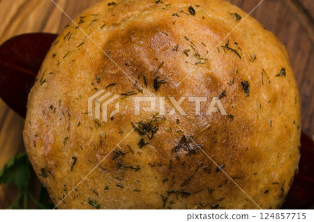 A pot with baked meat and a bread lid on a wooden A pot with baked meat and a bread lid on a wooden 124857715