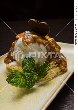 Dessert with puff pastry and ice cream drizzled Dessert with puff pastry and ice cream drizzled 124857729