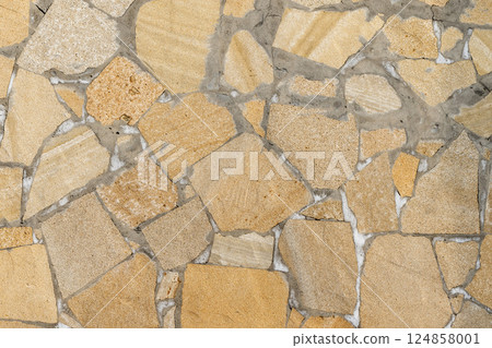 Yellow and beige mosaic-style stone wall offering a rough texture Yellow and beige mosaic-style stone wall offering a rough texture 124858001