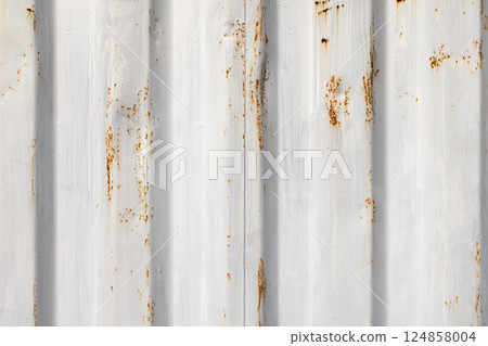 Rust spots are over white paint on corrugated metal, background texture 124858004