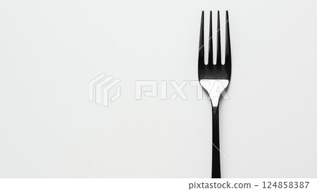 Elegant Black Fork on White Background Perfect for Dining Setting 124858387