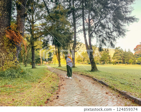 Woman walking and relaxing at beautyful green landscape of Handara Woman walking and relaxing at beautyful green landscape of Handara 124859374