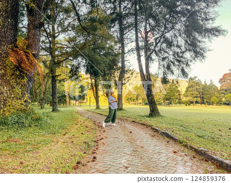 Woman walking and relaxing at beautyful green landscape of Handara Woman walking and relaxing at beautyful green landscape of Handara 124859376