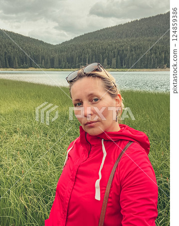 Woman in red windbreaker near the Black Lake in the Durmitor national park 124859386