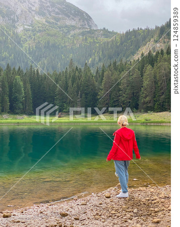Woman in red windbreaker near the Black Lake in the Durmitor national park 124859389