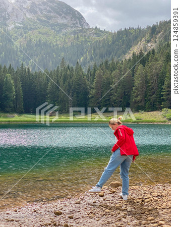 Woman in red windbreaker near the Black Lake in the Durmitor national park 124859391