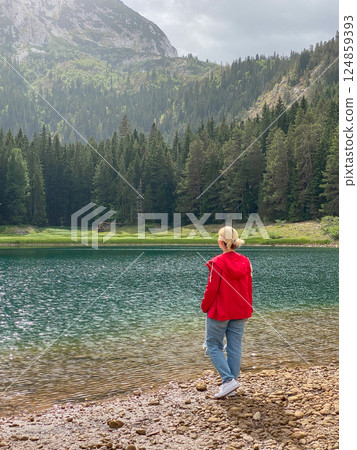 Woman in red windbreaker near the Black Lake in the Durmitor national park 124859393