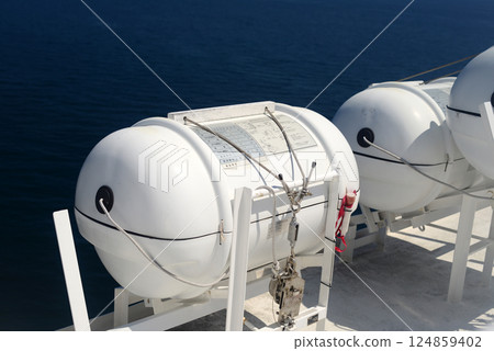 Life raft capsule on the side of the ferry boat -1 124859402