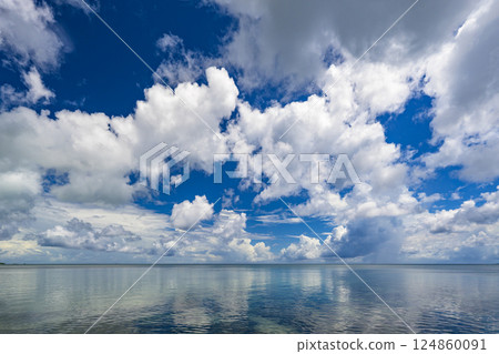 Dynamic clouds and clear blue skies over the tropical island of Ishigaki 124860091