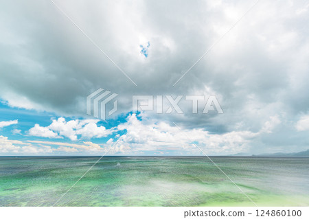 Dynamic clouds and clear blue skies over the tropical island of Ishigaki 124860100